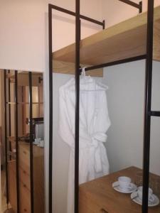 a white shirt is hanging in a closet at Sugar Hotel in Cape Town