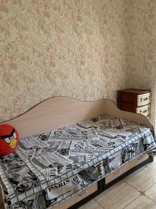 a bedroom with a bed with a bed frame with newspapers at 131 проспект Добровольского Хорошая 3-х комнатная квартира в Одессе in Odesa