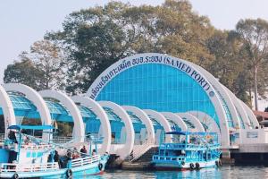 two boats in the water in front of a building at Samed Port View in Ko Samed