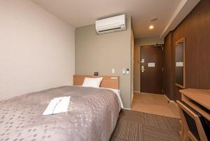 Postel nebo postele na pokoji v ubytování Amagasaki Plaza Hotel Hanshin Amagasaki + 19 fotografií