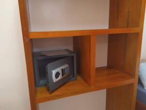 a small microwave on a shelf in a room at JPH Resort in Malapascua Island