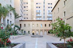 a courtyard with a fountain in front of a building at 107 - King David Residence - Jerusalem-Rent in Jerusalem