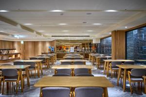 a row of tables and chairs in a restaurant at Shine Mood Resort Yuanli in Yuanli