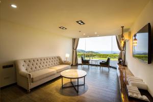 a living room with a couch and a table at Fu Yuan Tan Villa in Fuyuan +36 photos