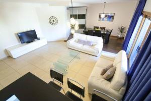 a living room with two white couches and a television at 202 - King David Residence - Jerusalem-Rent in Jerusalem