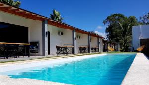 a swimming pool in front of a house at Positano Alona Beach Panglao in Panglao