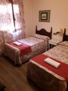 Ein Bett oder Betten in einem Zimmer der Unterkunft Hostal Rocio