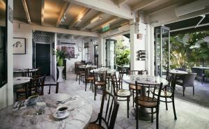 a restaurant with tables and chairs on a patio at Muntri Mews in George Town