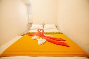 Postel nebo postele na pokoji v ubytování Putra Dadi Guest House
