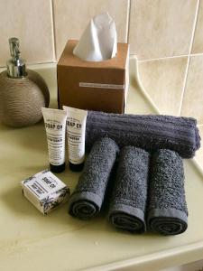 a group of towels and a box on a counter at Beltie Park Homestead in Wangaratta