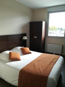 a bedroom with a large bed with a large window at Le Port de Decize in Decize