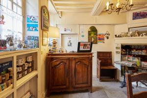 a shop with a wooden counter in a room at Hotel Saint Etienne in Caen