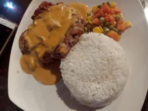 a plate of food with rice and meat and vegetables at James Homestay in Siquijor