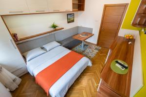 a small bedroom with a bed and a table at Studio DOLCE VITA in Varna City