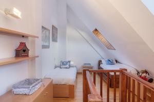 a attic room with two beds and a staircase at Torán by Totiaran in Baqueira-Beret