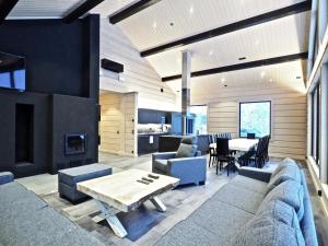 a living room with a couch and a table at Levillas Kuppimaantie Villas in Levi