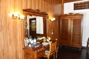 a wooden room with a desk and a mirror at Nilaveli Beach Resort - Level 1 Certified in Nilaveli
