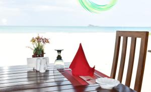 a dining room table with red napkins on it at Nilaveli Beach Resort - Level 1 Certified in Nilaveli