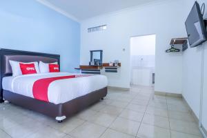 Un pat sau paturi într-o cameră la SUPER OYO 1755 De'balcon Accomodation Near Ngurah Rai Airport