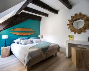 a bedroom with a bed with a surfboard on the wall at Gîte de l Ange - Au cœur du Centre Ville in Colmar