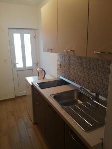 a kitchen with a sink and a counter top at Apartman Put in Baška