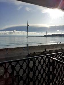 a view of the beach with a rainbow in the sky at The Edenhurst Guesthouse in Weymouth