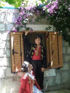 a young boy is standing in a window at Luštica Apartments in Lustica