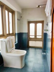 a bathroom with a white toilet in a room at Hotel Central Bhaktapur in Bhaktapur