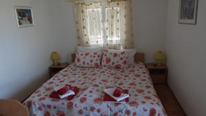 a bedroom with a bed with red shoes on it at Luštica Apartments in Luštica