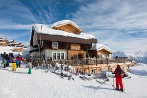 a group of people standing in front of a ski lodge at Hamilton Lodge & Spa in Belalp