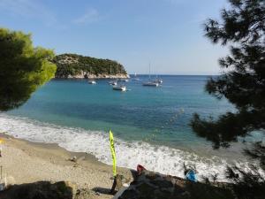 a view of a beach with boats in the water at Stafylos Suites & Boutique hotel in Stafylos