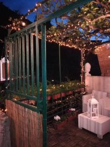 a pergola with christmas lights on a patio at Rio Groppo Guesthouse in Manarola