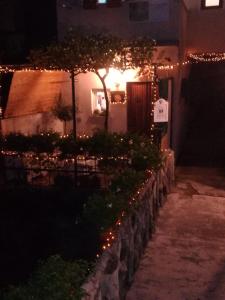 a house with lights on the side of it at night at Rio Groppo Guesthouse in Manarola