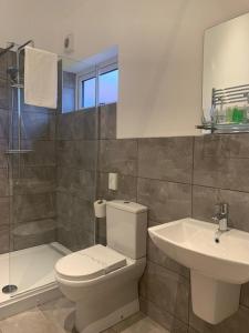 a bathroom with a toilet and a sink at Oakwood Farm Mews Chester in Chester