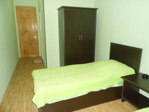 a bedroom with a bed and a cabinet and a desk at Hotel Star in Akhaltsikhe