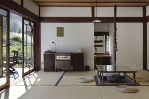 a living room with a table and some windows at The Lodge MIWA in Kyoto