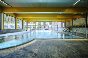 ein leerer Pool in einem großen Gebäude mit Fenstern in der Unterkunft Sonnenresort Ettershaus in Bad Harzburg