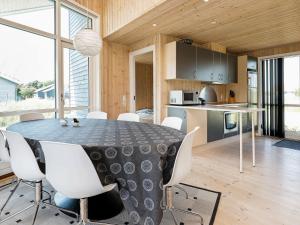 a kitchen and dining room with a table and chairs at 6 person holiday home in Ulfborg in Fjand Gårde