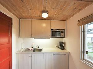 a kitchen with a sink and a microwave at Holiday home in Tyringe in Tyringe