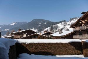 a group of buildings with snow on the roofs at Appartement Flocon de Nell in Meg&egrave;ve
