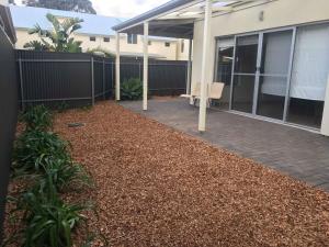 a patio in front of a house with a chair at Gawler Townhouse 1 Bedroom in Gawler