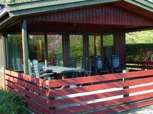 a screened in porch with a table and chairs at 6 person holiday home in Pr st in Togeholt