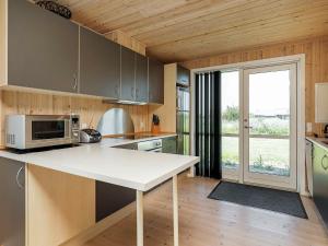 a kitchen with a white counter and a microwave at 6 person holiday home in Ulfborg in Fjand Gårde