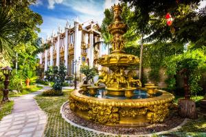 a large gold fountain in front of a building at Pingdoi Hualin Boutique Hotel in Chiang Mai