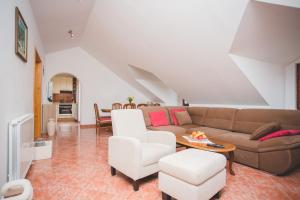 a living room with a couch and a table at Apartmani Bauk in Pučišća