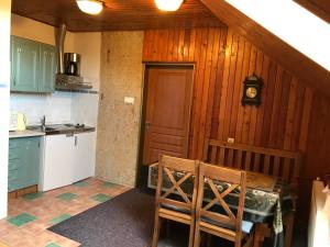 a kitchen with a table and chairs in a room at Penzion Trampska Bouda in Abertamy