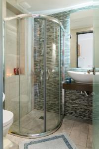 a bathroom with a shower and a toilet and a sink at Kalidonio Studios in Kalamaki