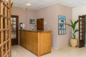 a reception desk in a room with a potted plant at Kalidonio Studios in Kalamaki