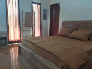 Postel nebo postele na pokoji v ubytování Yuda Homestay