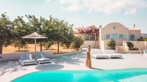 a pool with chairs and an umbrella and a house at Sienna Eco Resort in Fira